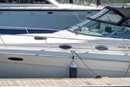 The Image of 1998 Sea Ray Sundancer 330 docked, featuring sleek design and white exterior. - 0