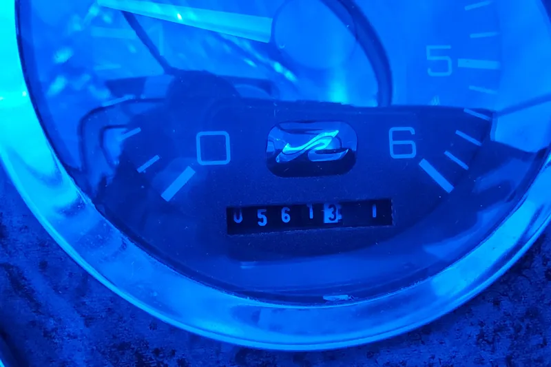 Slide: The Image of Close-up of a Sea Ray Sundancer 330 gauge, displaying 5613 hours. - 11