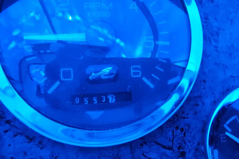 Slide: The Image of Close-up of a Sea Ray Sundancer 330 tachometer, displaying 5537 RPM, blue lighting. - 12