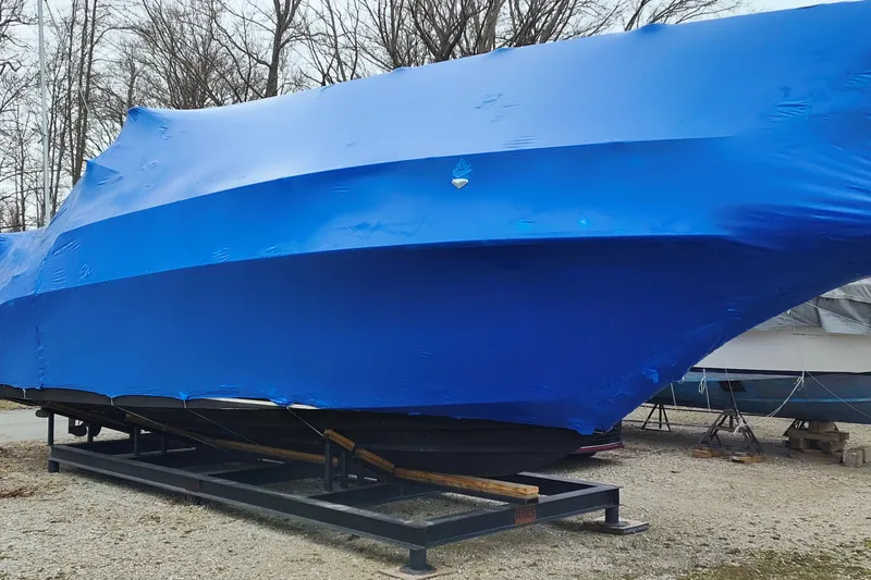 Slide: The Image of 1998 Sea Ray Sundancer 330 boat covered in blue tarp, stored outdoors. - 13