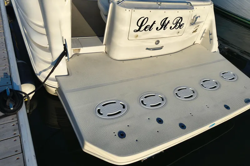 Slide: The Image of 1998 Sea Ray Sundancer 330 boat with "Let It Be" on the stern, docked at marina. - 2