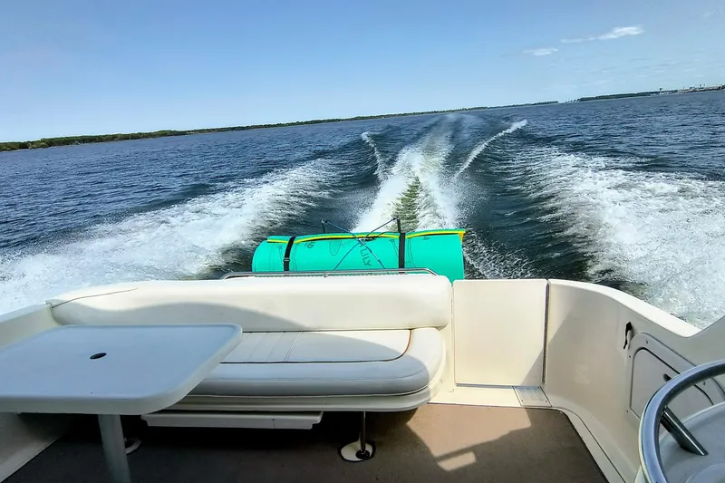 Slide: The Image of 1998 Sea Ray Sundancer 330 cruising on open water, leaving a wake behind. - 3