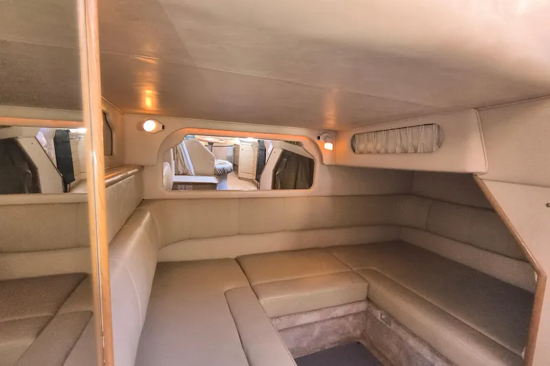 Slide: The Image of 1998 Sea Ray Sundancer 330 cabin interior with beige seating and ambient lighting. - 7