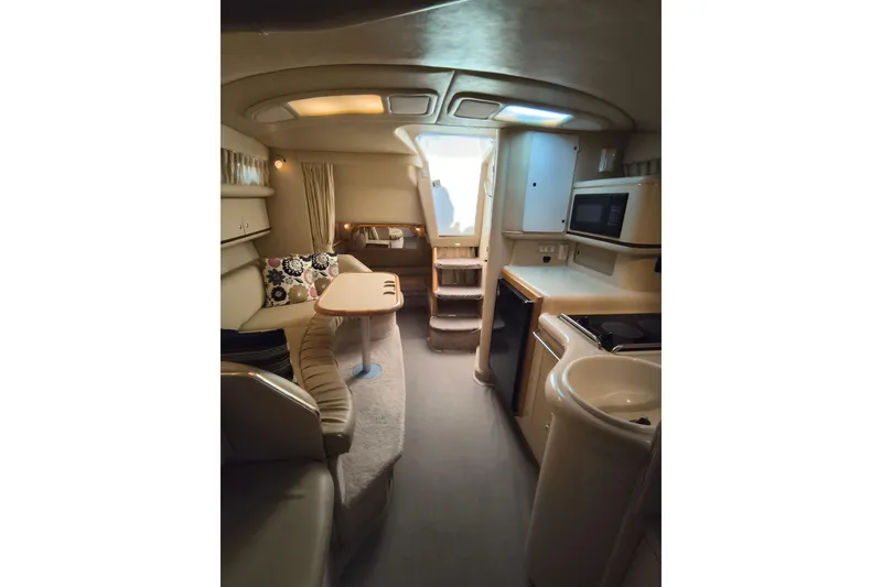 Slide: The Image of Interior of 1998 Sea Ray Sundancer 330 yacht with kitchenette and seating area. - 9