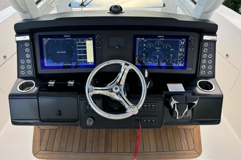 Slide: The Image of 2025 Robalo R360 Center Console dashboard with dual Simrad displays and modern controls. - 23