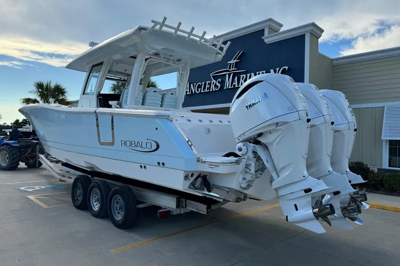 Slide: The Image of 2025 Robalo R360 Center Console boat with triple Yamaha engines at Anglers Marine. - 3