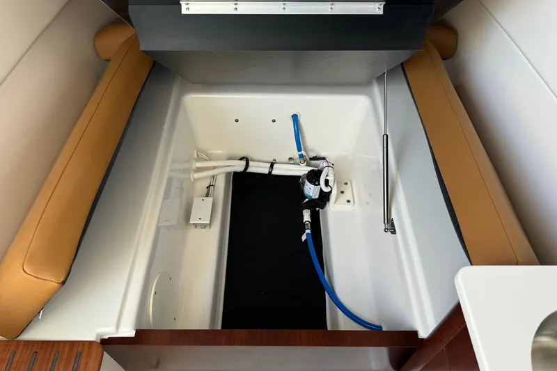 Slide: The Image of 2025 Robalo R360 Center Console interior compartment with seating and plumbing components. - 31