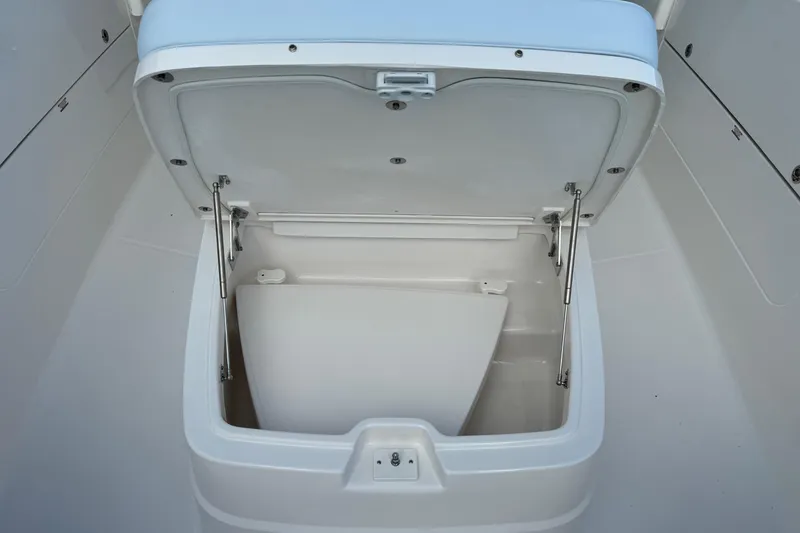 Slide: The Image of 2025 Robalo R360 Center Console storage compartment with open lid, showcasing interior space. - 33