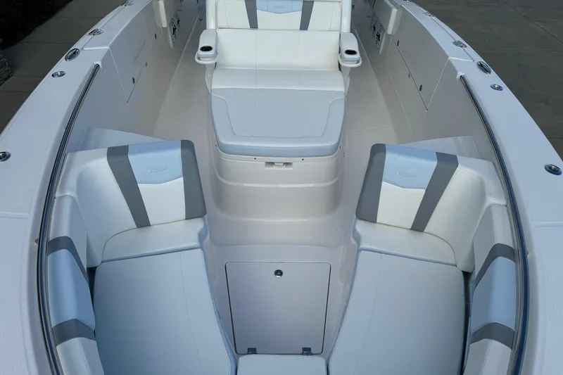 Slide: The Image of 2025 Robalo R360 Center Console boat interior with white and gray seating. - 36
