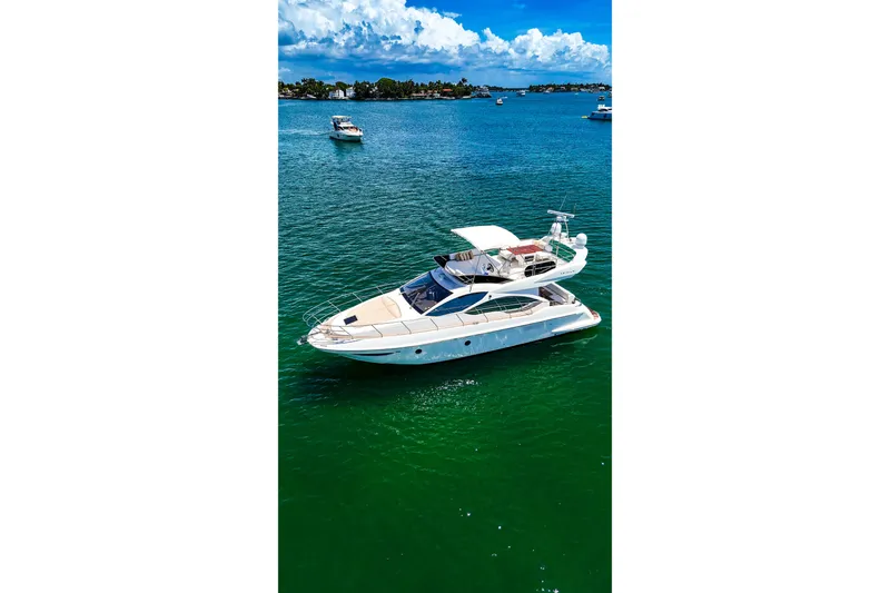 Slide: The Image of 2013 Azimut 45 yacht cruising on clear blue water under a sunny sky. - 3