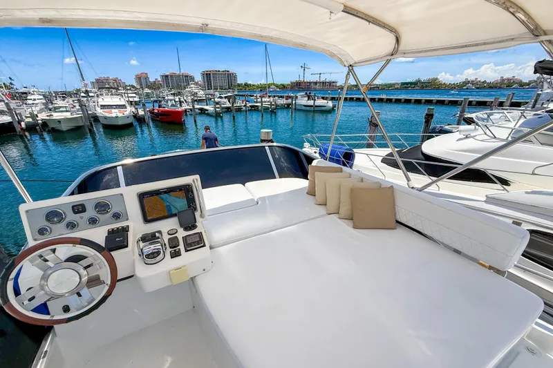 Slide: The Image of Flybridge of 2013 Azimut 45 yacht with helm and seating, docked at marina. - 4