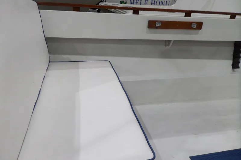 Slide: The Image of White cushioned seating on a 1980 Lyman-Morse Fisherman Sleeper boat interior. - 11