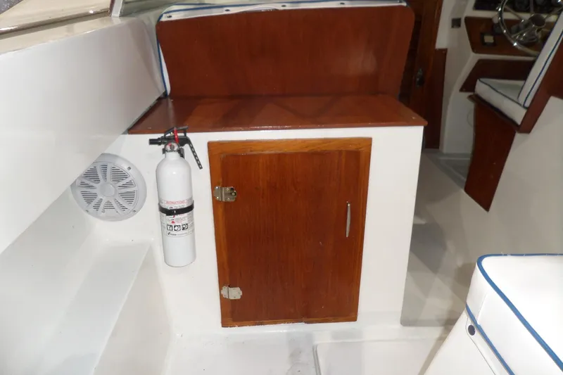 Slide: The Image of 1980 Lyman-Morse Fisherman Sleeper interior with wooden cabinet and fire extinguisher. - 13