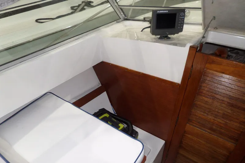 Slide: The Image of 1980 Lyman-Morse Fisherman Sleeper boat interior with navigation equipment and wooden paneling. - 17