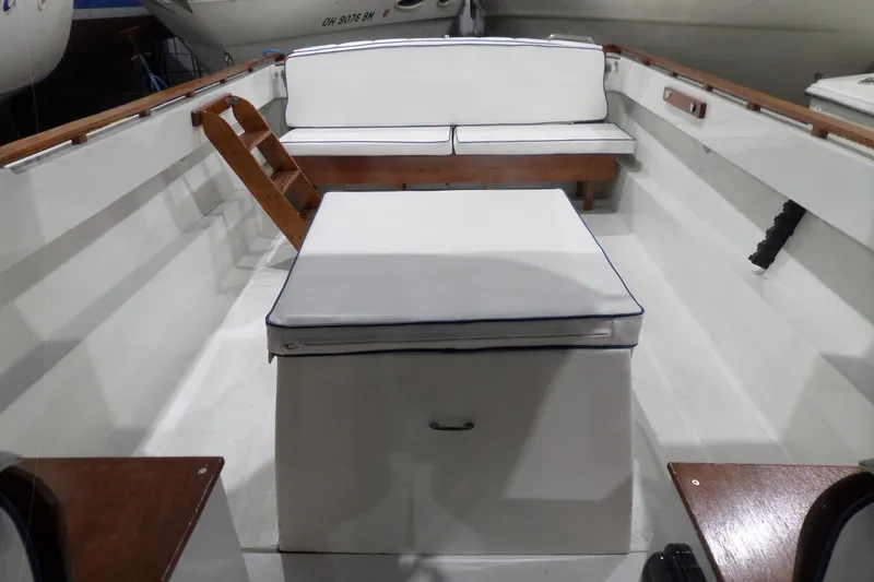 Slide: The Image of 1980 Lyman-Morse Fisherman Sleeper boat interior with cushioned seating and wooden accents. - 27