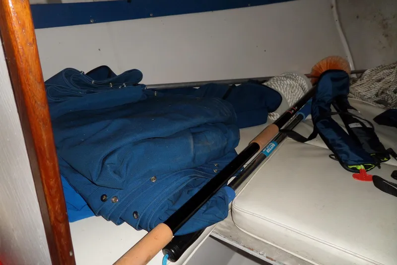 Slide: The Image of Interior of 1980 Lyman-Morse Fisherman Sleeper with fishing gear and blue fabric. - 28