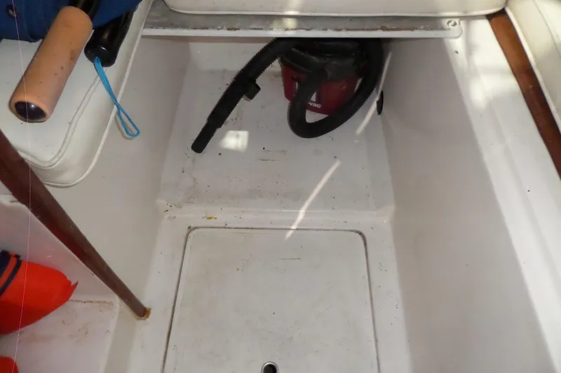 Slide: The Image of 1980 Lyman-Morse Fisherman Sleeper boat interior with storage compartment and vacuum. - 30