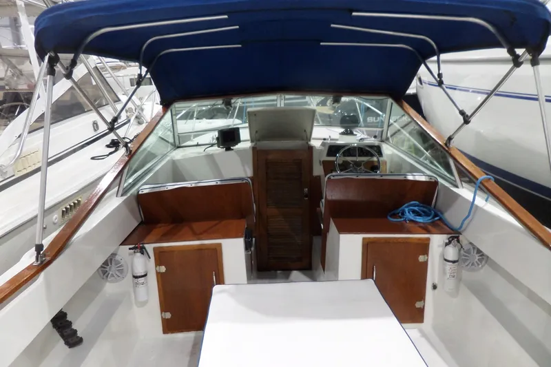 Slide: The Image of 1980 Lyman-Morse Fisherman Sleeper boat interior with blue canopy and wooden accents. - 40