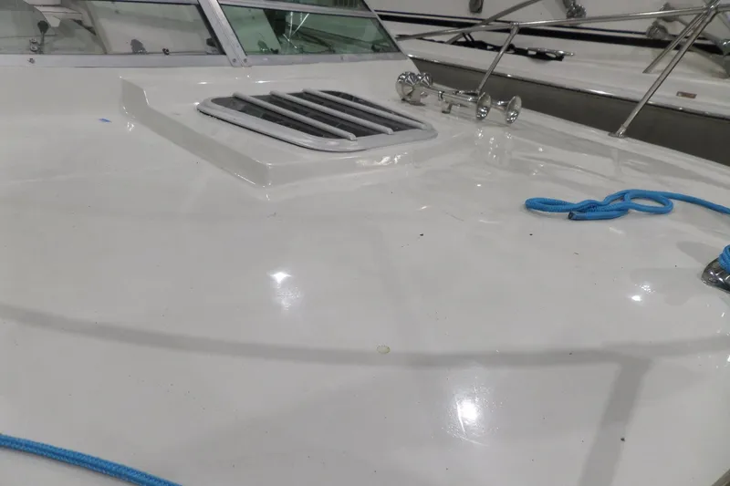 Slide: The Image of 1980 Lyman-Morse Fisherman Sleeper boat deck with blue rope and hatch. - 43