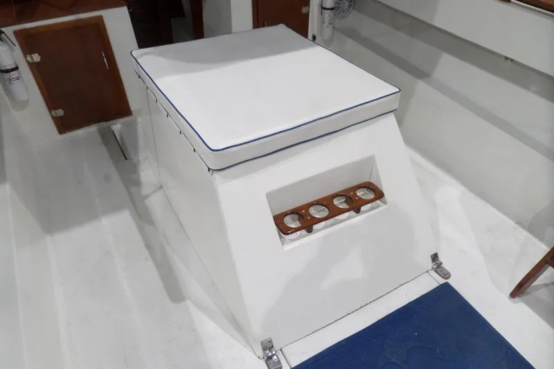 Slide: The Image of 1980 Lyman-Morse Fisherman Sleeper boat interior with cushioned seating and wooden cup holders. - 10