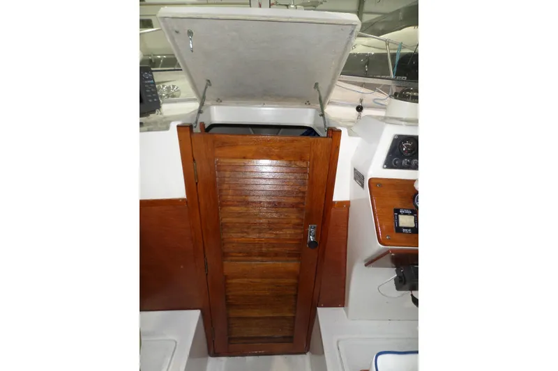 Slide: The Image of 1980 Lyman-Morse Fisherman Sleeper boat interior with wooden hatch and control panel. - 19