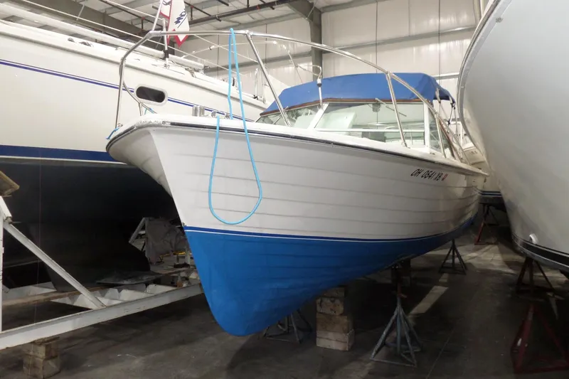 Slide: The Image of 1980 Lyman-Morse Fisherman Sleeper boat with blue hull in storage facility. - 2
