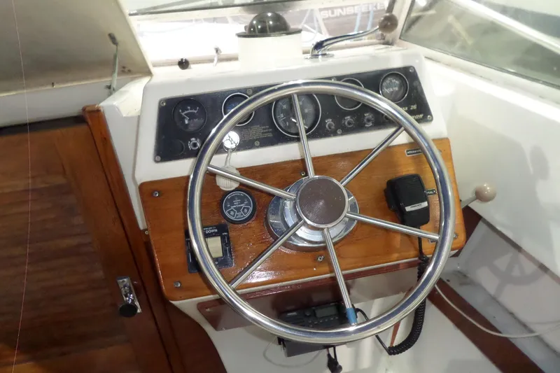 Slide: The Image of 1980 Lyman-Morse Fisherman Sleeper boat helm with steering wheel and control panel. - 20