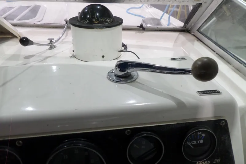Slide: The Image of 1980 Lyman-Morse Fisherman Sleeper boat dashboard with compass and control lever. - 23