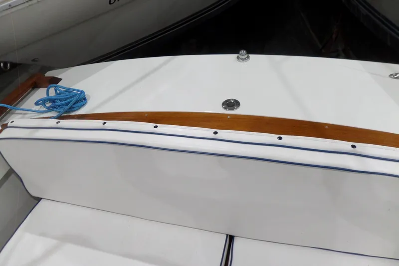 Slide: The Image of 1980 Lyman-Morse Fisherman Sleeper boat deck with blue rope and wooden trim. - 38