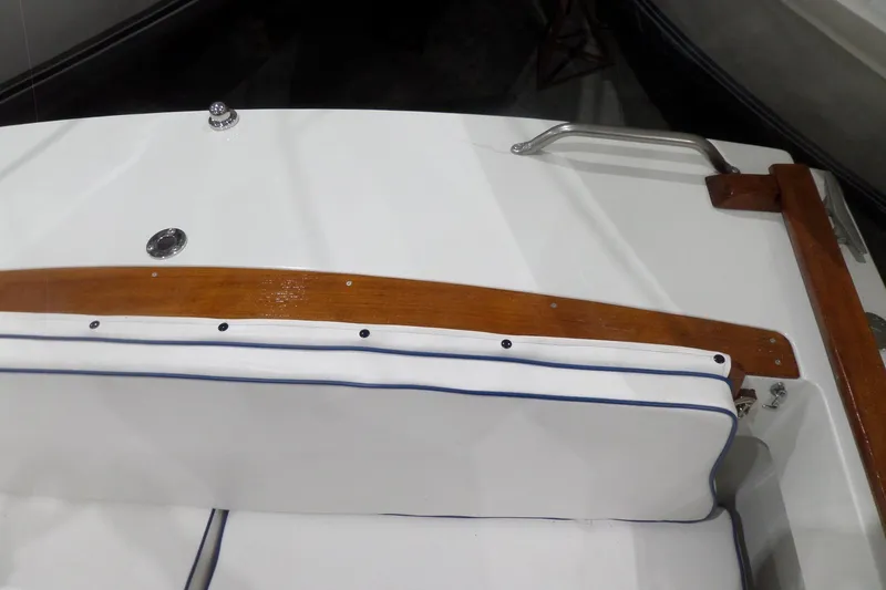 Slide: The Image of 1980 Lyman-Morse Fisherman Sleeper boat interior with white seating and wooden trim. - 39