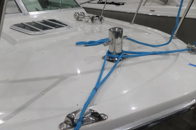 Slide: The Image of 1980 Lyman-Morse Fisherman Sleeper boat deck with blue ropes and chrome fittings. - 44