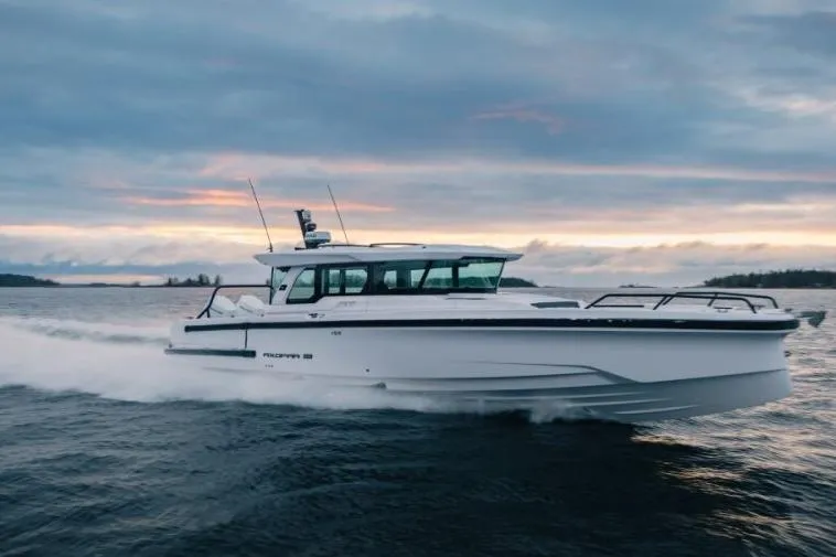 The Image of 2027 Axopar 38 Cross Cabin cruising on open water at sunset. - 0