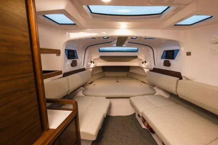 Slide: The Image of Luxurious interior of 2027 Axopar 38 Cross Cabin with modern seating and skylights. - 5