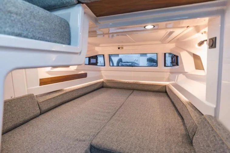 Slide: The Image of 2027 Axopar 38 Cross Cabin interior with spacious seating and modern design. - 6