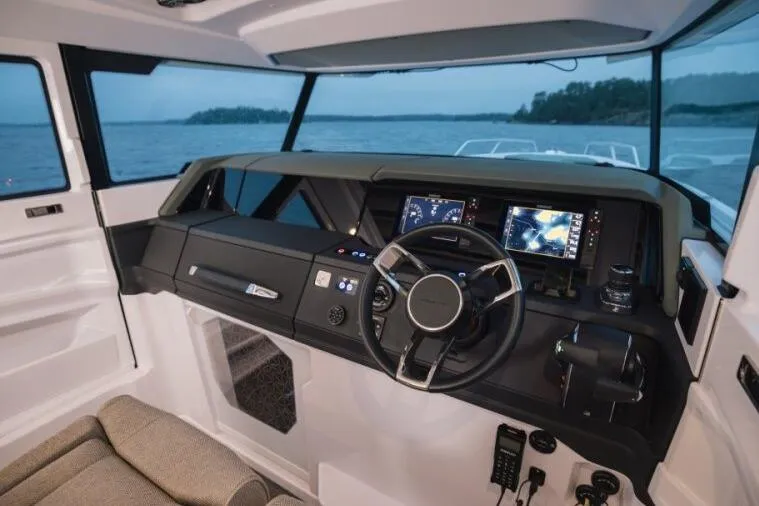 Slide: The Image of Interior view of 2027 Axopar 38 Cross Cabin boat with modern dashboard and navigation screens. - 8