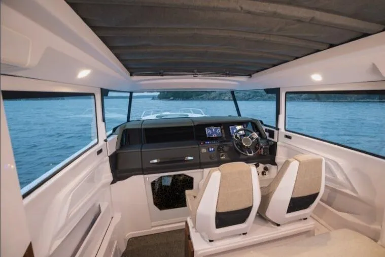 Slide: The Image of Interior view of 2027 Axopar 38 Cross Cabin boat with modern dashboard and seating. - 9