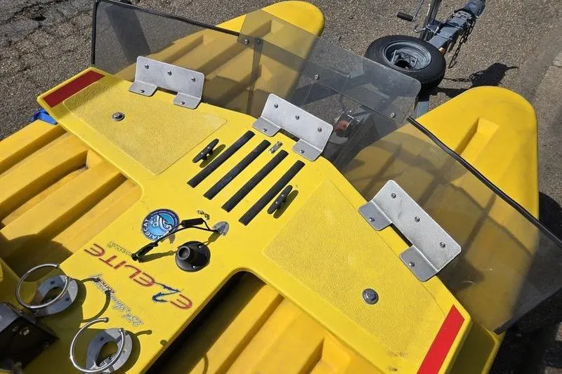 Slide: The Image of Yellow 2019 CraigCat CATCHIT boat with windshield and control panel, parked on trailer. - 12
