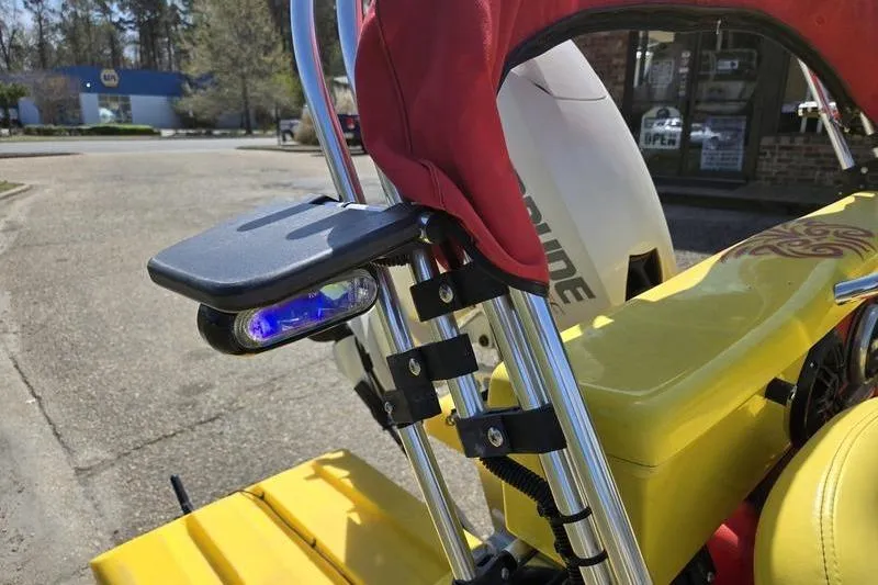 Slide: The Image of 2019 CraigCat CATCHIT with red seat and blue light, parked outdoors. - 2