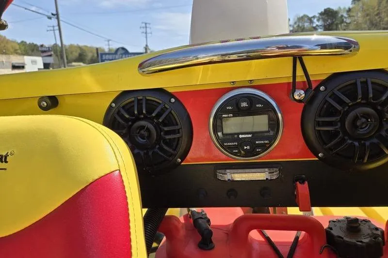 Slide: The Image of Interior of a 2019 CraigCat CATCHIT with JBL audio system and vibrant yellow-red seats. - 9