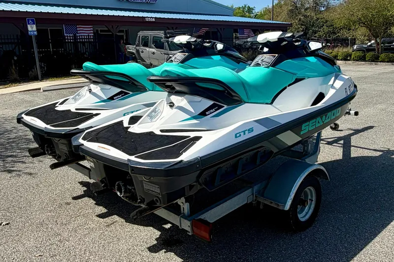 Slide: The Image of 2018 Sea-Doo GTS jet skis on a trailer in a parking lot. - 5
