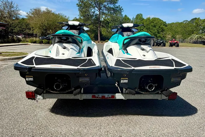 Slide: The Image of Two 2018 Sea-Doo GTS jet skis on a trailer in a parking lot. - 6