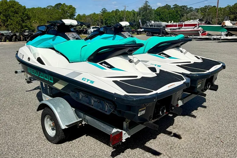 Slide: The Image of 2018 Sea-Doo GTS jet skis on trailer, parked outdoors. - 7
