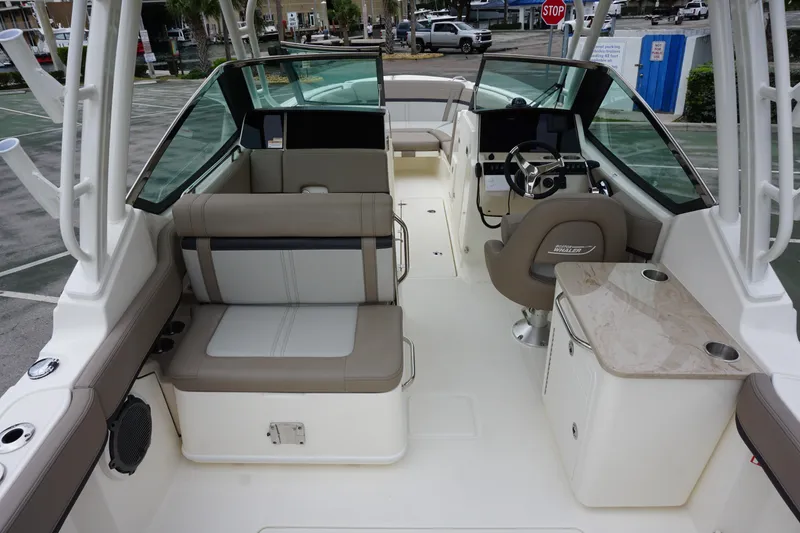 Slide: The Image of 2026 Boston Whaler 240 Vantage boat interior with seating, helm, and table. - 10