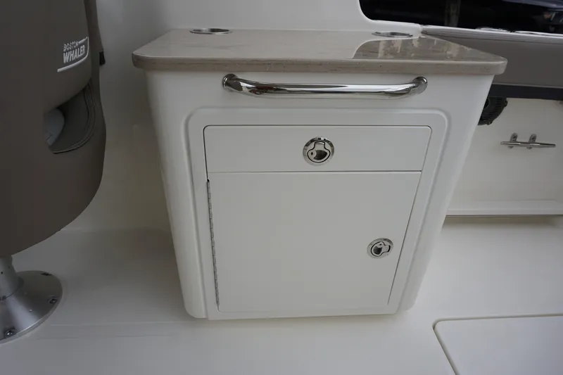 Slide: The Image of Storage compartment on a 2026 Boston Whaler 240 Vantage boat interior. - 14