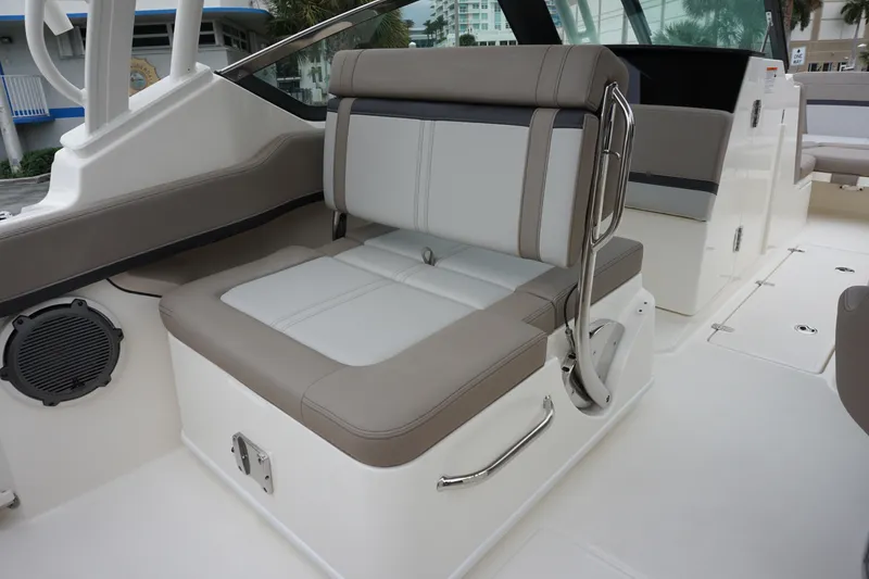 Slide: The Image of 2026 Boston Whaler 240 Vantage boat interior with cushioned seating and sleek design. - 16