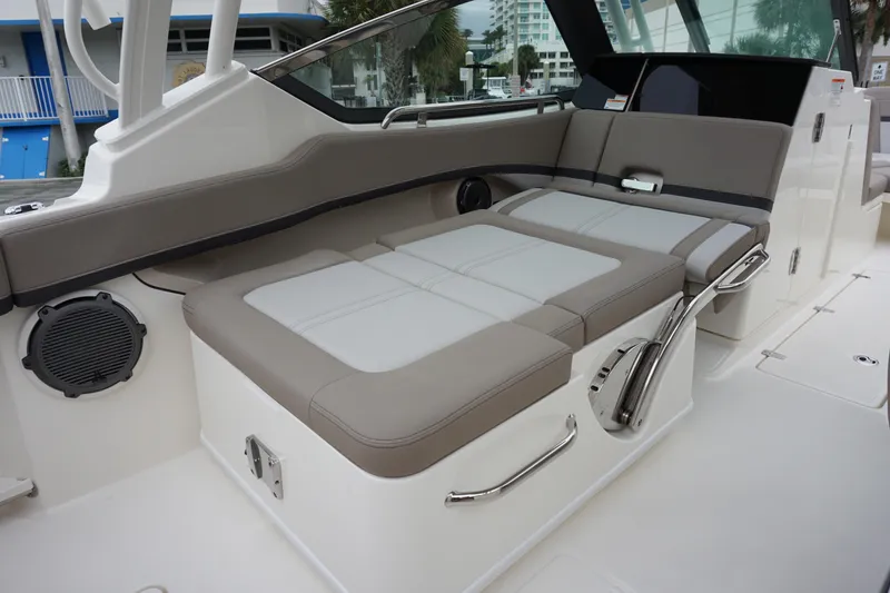 Slide: The Image of 2026 Boston Whaler 240 Vantage boat interior with cushioned seating and sleek design. - 17