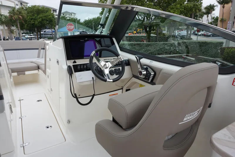 Slide: The Image of 2026 Boston Whaler 240 Vantage boat interior with modern helm and seating. - 19