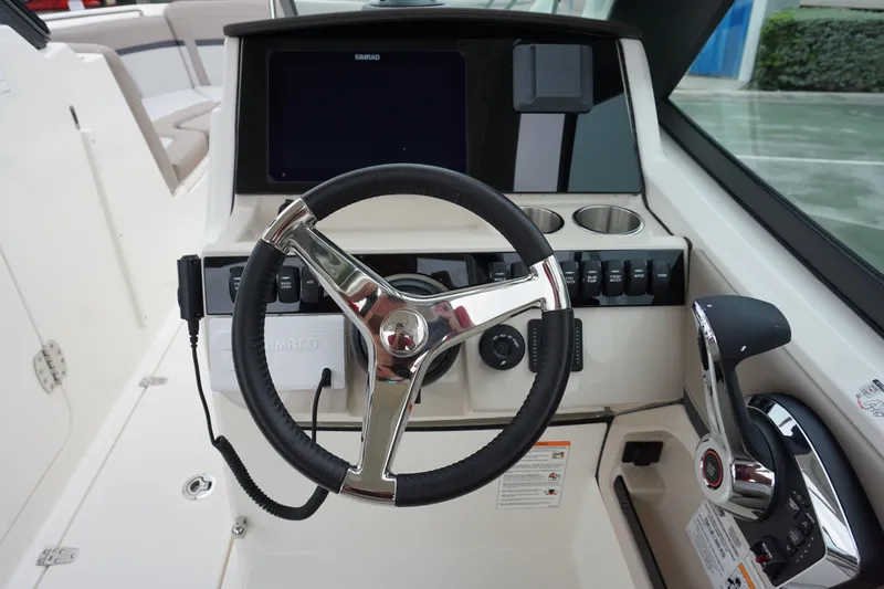 Slide: The Image of Steering console of 2026 Boston Whaler 240 Vantage with modern controls and display. - 20