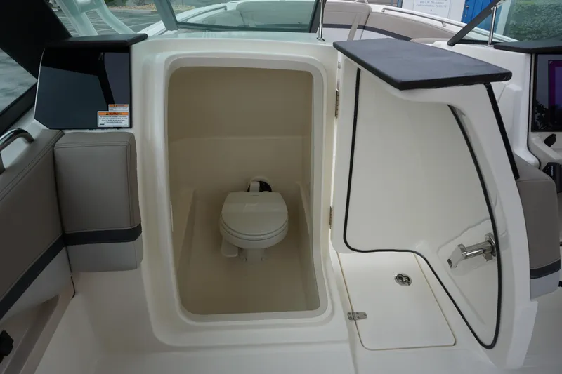 Slide: The Image of Boston Whaler 240 Vantage 2026 boat interior with compact marine toilet. - 25