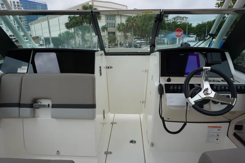 Slide: The Image of 2026 Boston Whaler 240 Vantage boat cockpit with steering wheel and seating. - 28